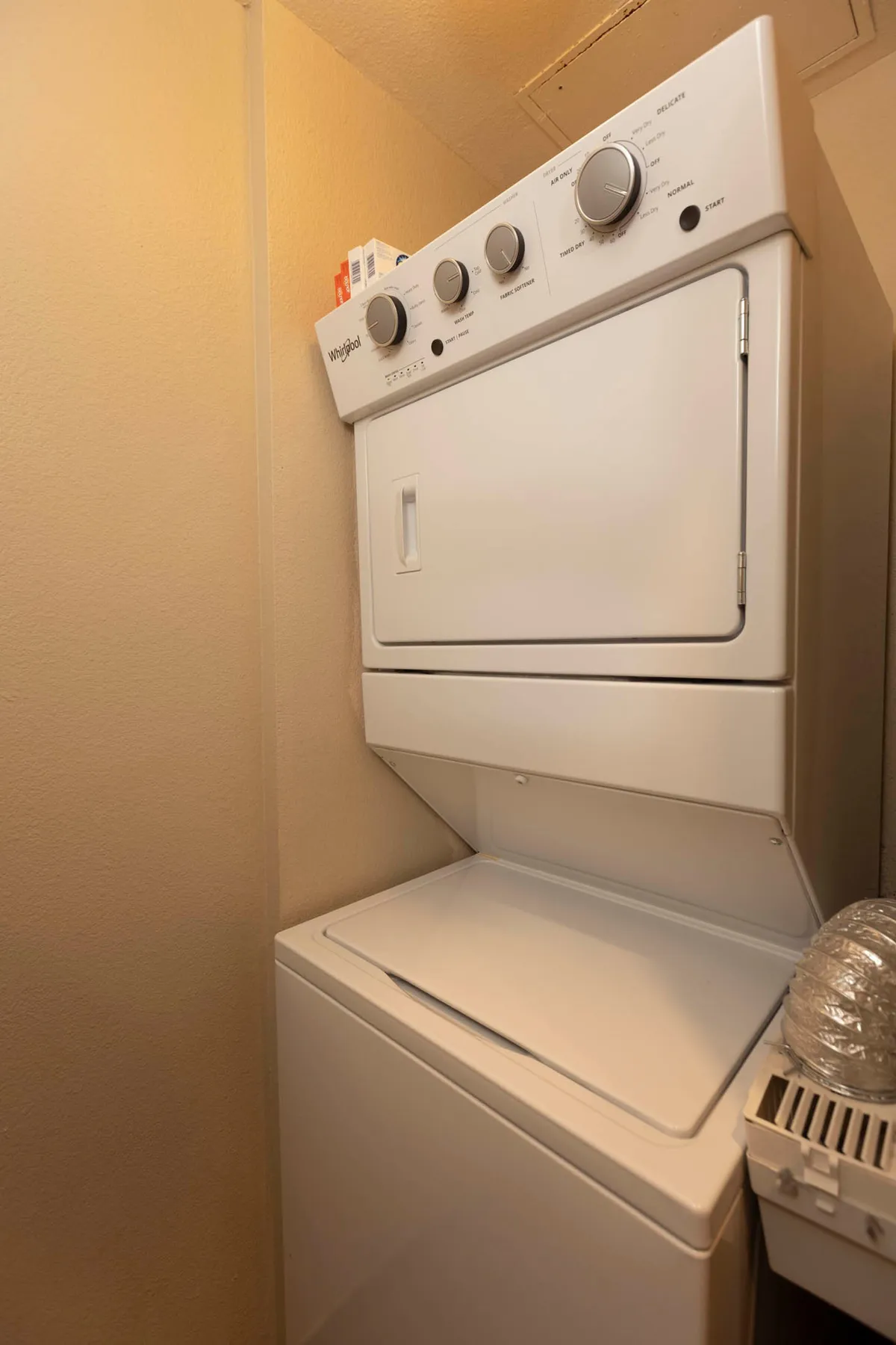 A stacked washer and dryer unit inside a dedicated laundry space, conveying cleanliness, convenience, and the ease of handling laundry chores during your stay.